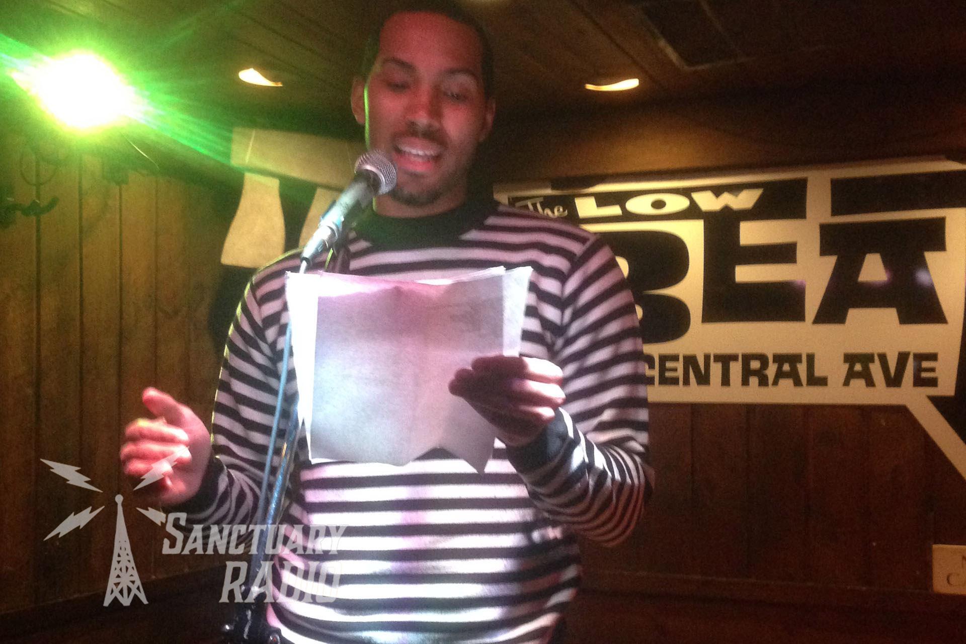 Luis "L-Majesty" Pubon reading into a mic at The Low Beat in Albany, NY