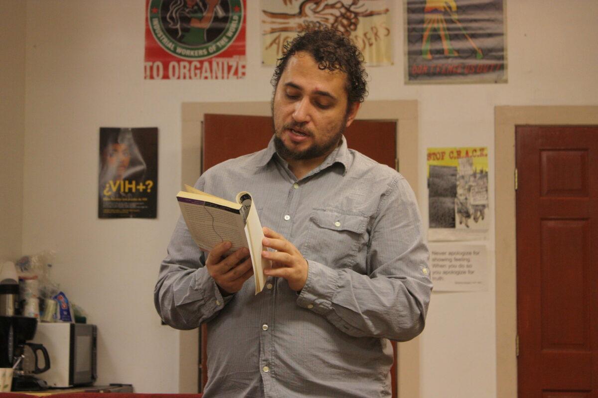 Photo of poet Victorio Reyes Asili reading at the Social Justice Center in Albany, NY
