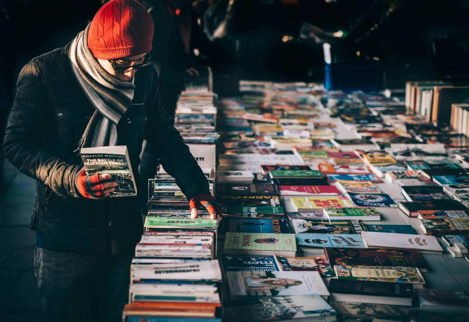 Man looking at books on a sale table