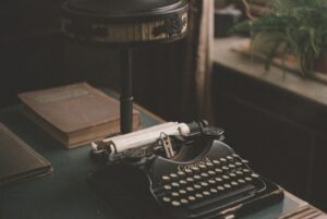 typewriter on table with books