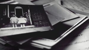 Grayscale Photography Of Pile Of Photographs